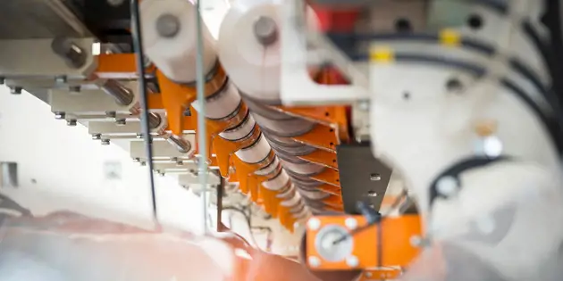 A tissue converting line in operation — converting and log-handling machinery